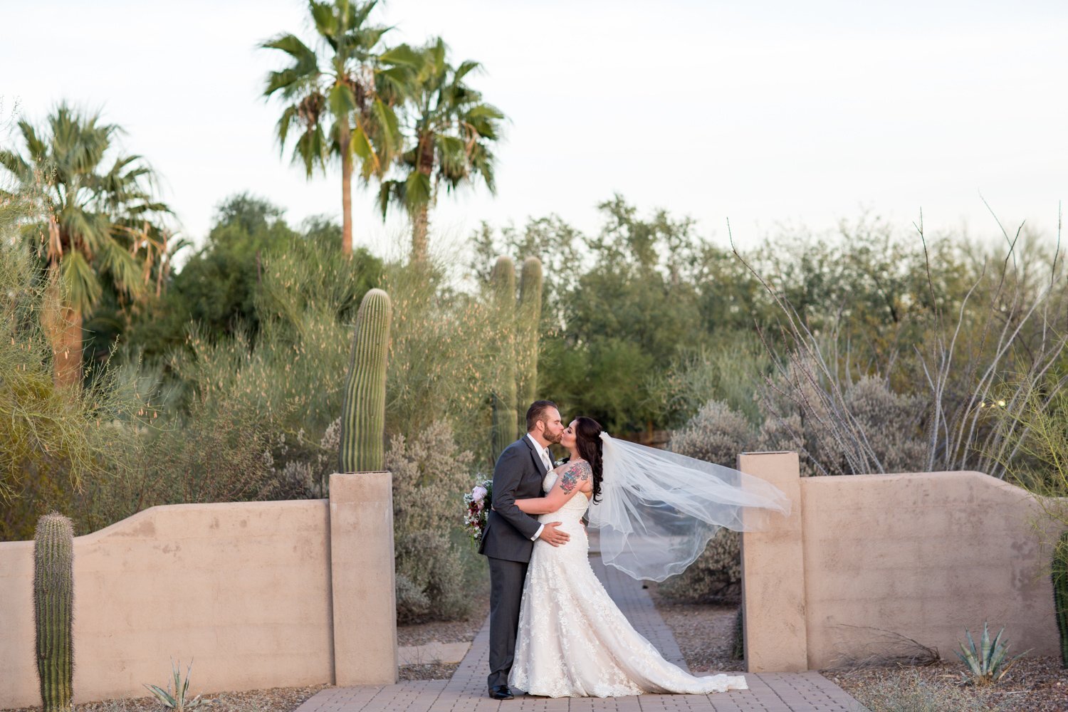 Bride and groom leaning into a kiss